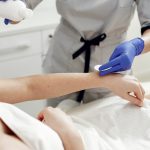 Beautiful girl doing hair removal. Woman in beauty salon