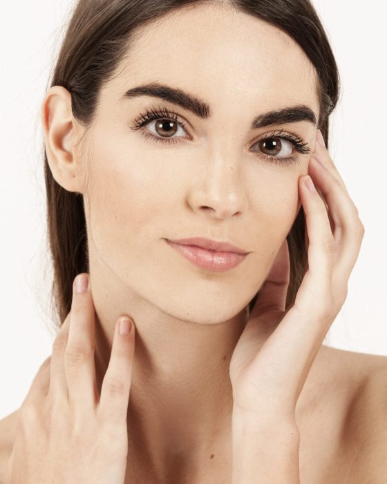 cute-woman-posing-touching-her-face